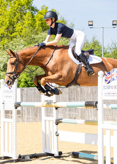 Horse and rider jumping over an obstacle in an equestrian competition