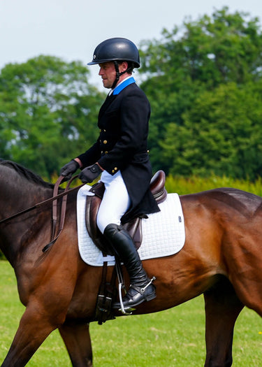 White competition dressage pad with a square pattern