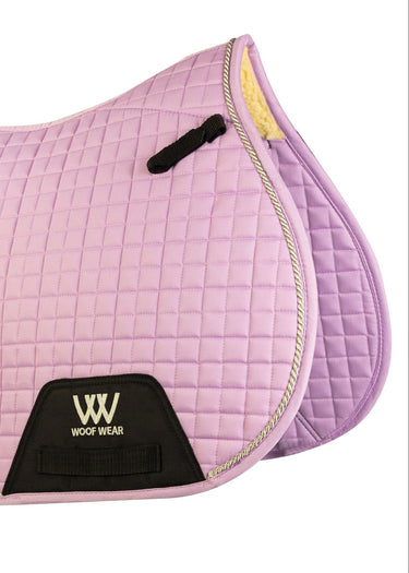 Pink quilted saddle pad with Woof Wear logo on a white background